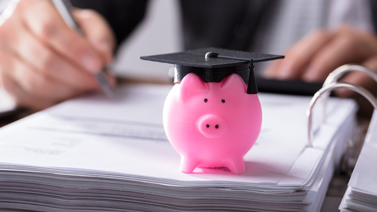 Piggy bank wearing a grad cap